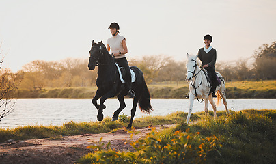 Image showing Horse riding, freedom and hobby with friends in nature on horseback by the lake during a summer morning. Countryside, equestrian and female riders outdoor together for travel, fun or adventure