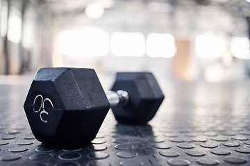 Image showing Dumbbell, exercise equipment and closeup in gym, wellness and health club for training. Fitness, weightlifting and iron weight for sport and muscle workout on the floor with mockup space on ground