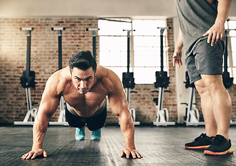 Image showing Push up, training and man or personal trainer in gym support, motivation and helping body builder in fitness. Muscle, strong and focus of people exercise or workout on floor, advice or accountability