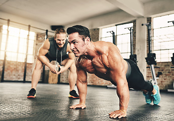 Image showing Push up, fitness and man or personal trainer in gym support, motivation and helping body builder in training. Muscle, strong and focus of people exercise or workout on floor, advice or accountability