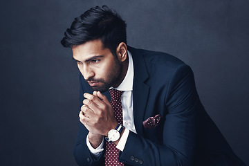 Image showing Business, thinking and Indian man with anxiety, depression and employee on a dark studio background. Male person, ceo or consultant with stress, planning or worry with mental health issue or confused