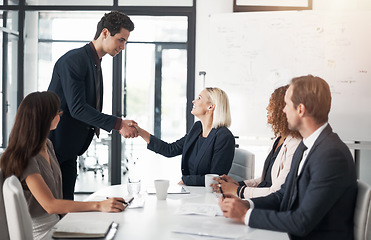 Image showing Business people, handshake and meeting for greeting, introduction or partnership in conference at office. Businessman shaking hands with woman in teamwork, b2b or deal for agreement at the workplace