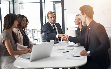 Image showing Business people, handshake and meeting for hiring, partnership or agreement in team conference at office. Businessman shaking hands with employee for recruiting, b2b and corporate growth at workplace