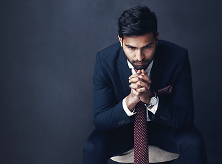 Image showing Business, thinking or Indian man with stress, anxiety or employee on a dark studio background. Male person, entrepreneur or consultant confused, planning or professional with company report or worry