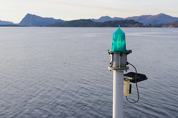 Image showing green marker light on breakwater when approaching the coast