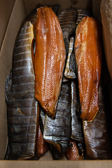 Image showing Smoked fish in craft paper box.