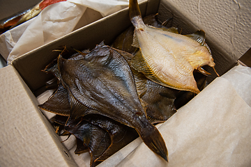 Image showing Smoked fish in craft paper box.