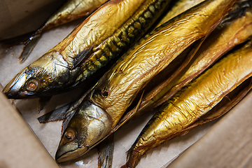 Image showing Smoked fish in craft paper box.