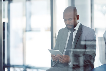 Image showing Tablet, lawyer and black man in office for business, research or online browsing. Serious, digital technology and corporate African attorney, person or professional reading email, internet app or web