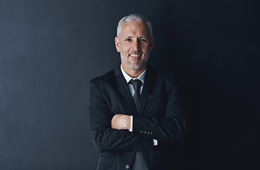 Image showing Arms crossed, happy and portrait of business man in studio for professional, corporate or manager. Boss, pride and confidence with face of male ceo on black background for executive and mockup space