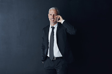 Image showing Phone call, happy and mature businessman in a studio for an online corporate or legal consultation. Smile, technology and professional senior male lawyer on a mobile conversation by black background.
