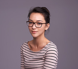 Image showing Portrait, fashion glasses and serious woman in studio isolated on a gray background mockup space. Face, nerd and female geek, person or model from Canada with trendy clothes, eyewear and casual style