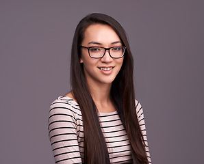 Image showing Portrait, fashion glasses and happy woman in studio isolated on a gray background mockup space. Face, nerd and female geek, person or model from Canada with trendy clothes, eyewear and casual style.