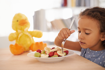 Image showing Eating child, morning and fruit salad at home with breakfast and wellness meal and vitamins. House, nutrition and young girl with healthy food and fruits of a hungry kid with youth at a table