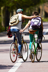 Image showing Men, students and friends with back, bicycle and sustainable transportation on road in summer sunshine. Young gen z people, eco cycling and outdoor together in street with travel on university campus