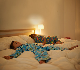 Image showing Brothers, sleep and night in bed for rest together, peace and health in family home. Young tired kids, boy children and tired with calm sleeping, fatigue and dream on blanket in bedroom at house