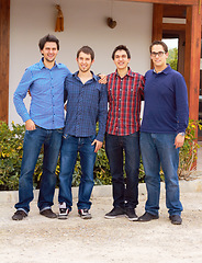 Image showing Group, causal and portrait of male friends together standing in an outdoor garden by their house. People, smile and full body of happy men in casual outfit standing with embrace in backyard or nature