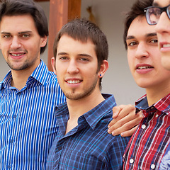 Image showing Group, men and portrait of brothers together standing in an outdoor garden by their house. Happy, smile and male people or friends in casual outfit standing with embrace in the backyard or nature.