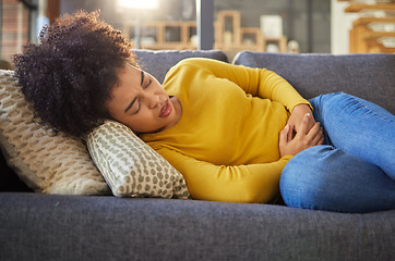 Image showing Stomach pain, sick and menstruation with woman on sofa for healthcare, endometriosis and tired. Digestion, medical and constipation with person in living room at home for nausea, virus and fear
