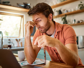 Image showing Tired, laptop and business man in kitchen for remote work, freelancer and mental health. Technology glitch, eye strain and frustrated with male person at home for burnout, exhausted and anxiety