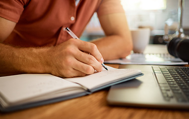 Image showing Man, hands and writing on book for notes, schedule planning or strategy on table at home. Closeup hand of male person with pen and notebook for ideas, reminder or information in research or studying