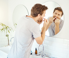 Image showing Dental floss, morning routine and mirror with man in bathroom for self care, oral hygiene and teeth. Cleaning, smile and health with face of male person at home for beauty, wellness and reflection