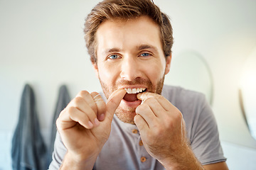 Image showing Teeth, dental floss and portrait of man in bathroom for self care, oral hygiene and morning routine. Cleaning, smile and health with face of male person at home for beauty, wellness and results