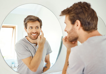 Image showing Bathroom, mirror and happy man with skincare cream for self care, skin hydration or home beauty treatment. Face cosmetics, dermatology smile or reflection of person with morning sunscreen application