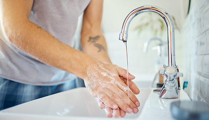 Image showing Soap, water and man washing hands at tap for skincare, healthy dermatology and safety of bacteria at home. Closeup, person and cleaning palm with foam at basin for hygiene routine, wellness or habit
