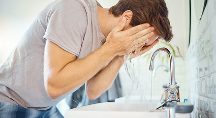 Image showing Man, bathroom and washing face at tap, water and morning skincare routine for grooming, beauty wellness or at home. Young guy, facial and cleaning at faucet, basin and wet splash for personal hygiene