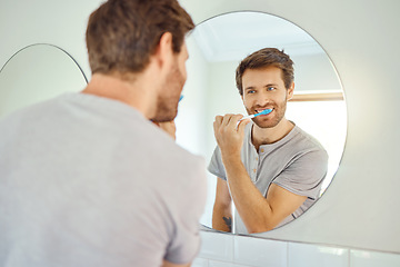 Image showing Brushing teeth, morning routine and mirror with man in bathroom for self care, oral hygiene and dental. Cleaning, smile and health with face of male person at home for beauty, wellness and reflection