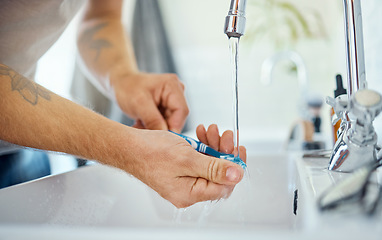 Image showing Hands, toothbrush or man at sink of water, dental hygiene or wellness of gum care at home. Closeup of person washing oral product for brushing teeth, fresh morning routine or cleaning at bathroom tap