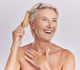 Image showing Senior woman, hair and brush with beauty and smile, styling locks and cosmetics on white background. Skin, antiaging and salon treatment with routine, female model and haircare tools with hairstyle