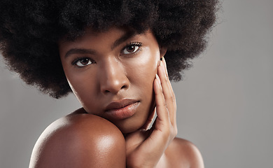 Image showing Black woman, portrait and skin, natural beauty and afro hair with glow isolated on studio background. African female model, cosmetic care and hand touching face, facial and shine with skincare