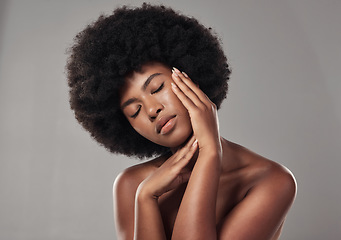 Image showing African, woman and skincare with feeling and facial treatment or wellness in studio background. Beauty, dermatology and hands on face with glowing, clear and healthy skin for self care with afro.