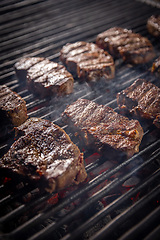 Image showing Steaks are generously covered in seasoning