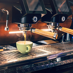 Image showing Cappuccino flowing into a coffee cup