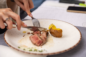 Image showing Grilled sliced steak with baked potatoes