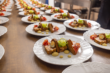 Image showing Multiple plates of beautifully presented food