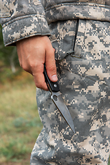 Image showing A man with a knife in the forest.