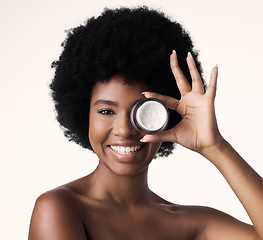 Image showing Black woman, cream and beauty, smile on face with cosmetics product and skincare on white background. Natural, afro hairstyle and African female model, dermatology with lotion and facial moisturizer