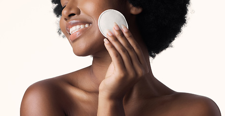 Image showing Black woman, beauty and cotton pad in hand with skincare and natural cosmetics on white background. Cleaning makeup from face, wellness and skin glow, African female model with smile and dermatology