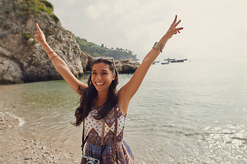 Image showing Travel, ocean or excited girl tourist on holiday, vacation or weekend trip for a fun adventure in Italy. Sea, view or happy woman with hands up, freedom or smile abroad sightseeing in nature journey
