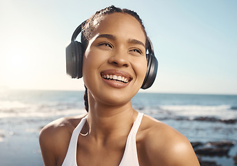 Image showing Thinking, headphones and woman at beach fitness, exercise or running mindset, training goals or inspiration music. Health, podcast and athlete, runner or sports person, sea listen and audio streaming