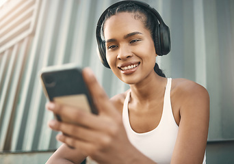 Image showing Fitness, phone or happy girl on social media in city listening to music or radio on exercise or running break. Headphones, funny meme or woman athlete runner on mobile app for a fun workout tutorial