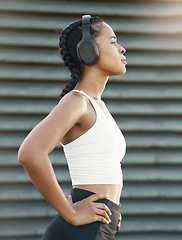 Image showing Headphones, tired woman or runner thinking of training, workout or exercise goal on break in city. Relax, resting or thoughtful sports girl athlete streaming radio music or fitness podcast to relax