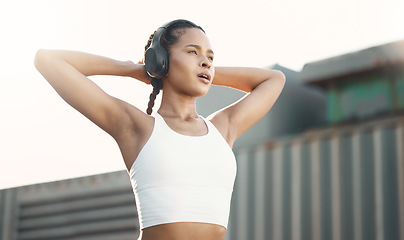 Image showing Stretching, outdoor and woman with headphones, exercise or streaming music with podcast, relax or stress relief. Female person, athlete or runner with headset, radio or wellness with training or rest