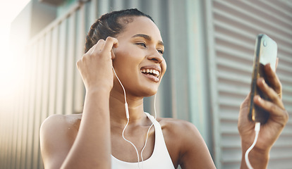 Image showing Fitness, woman with smartphone and listening to music for motivation with lens flare. Happy or health wellness, workout or exercise and female athlete listen to podcast in sportswear for resilience