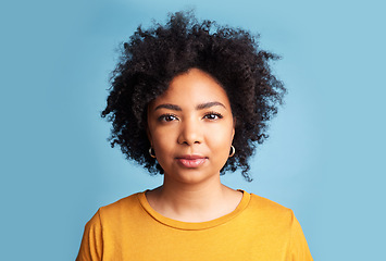 Image showing Portrait, woman and serious mindset on blue background in studio with natural beauty, confidence and focus. Face, college student and girl with a healthy afro or African haircare in salon