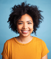 Image showing Smile, African woman and portrait with natural beauty, confidence or makeup on studio blue background. Face, happiness and person with curly hair, afro or cosmetics in salon for hairstyle care